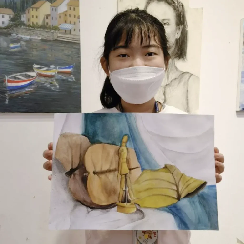 Student sketching creative portfolio piece during DSA preparation class