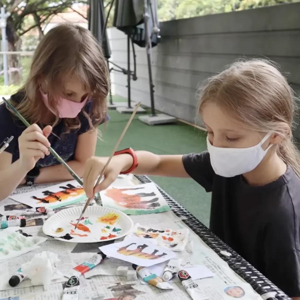 Child creating art with acrylics and clay during trial class at Visual Arts Centre
