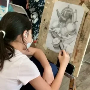 Student practicing advanced pencil drawing in a professional drawing course