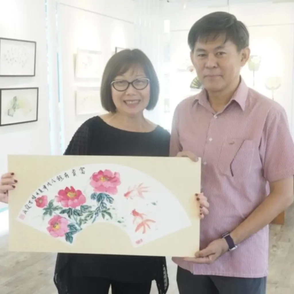 Student practicing Chinese ink painting and calligraphy with brush on paper