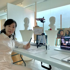 Artist participating in a Zoom live drawing class, learning sketching techniques