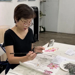 Students learning traditional Chinese ink painting techniques in Singapore
