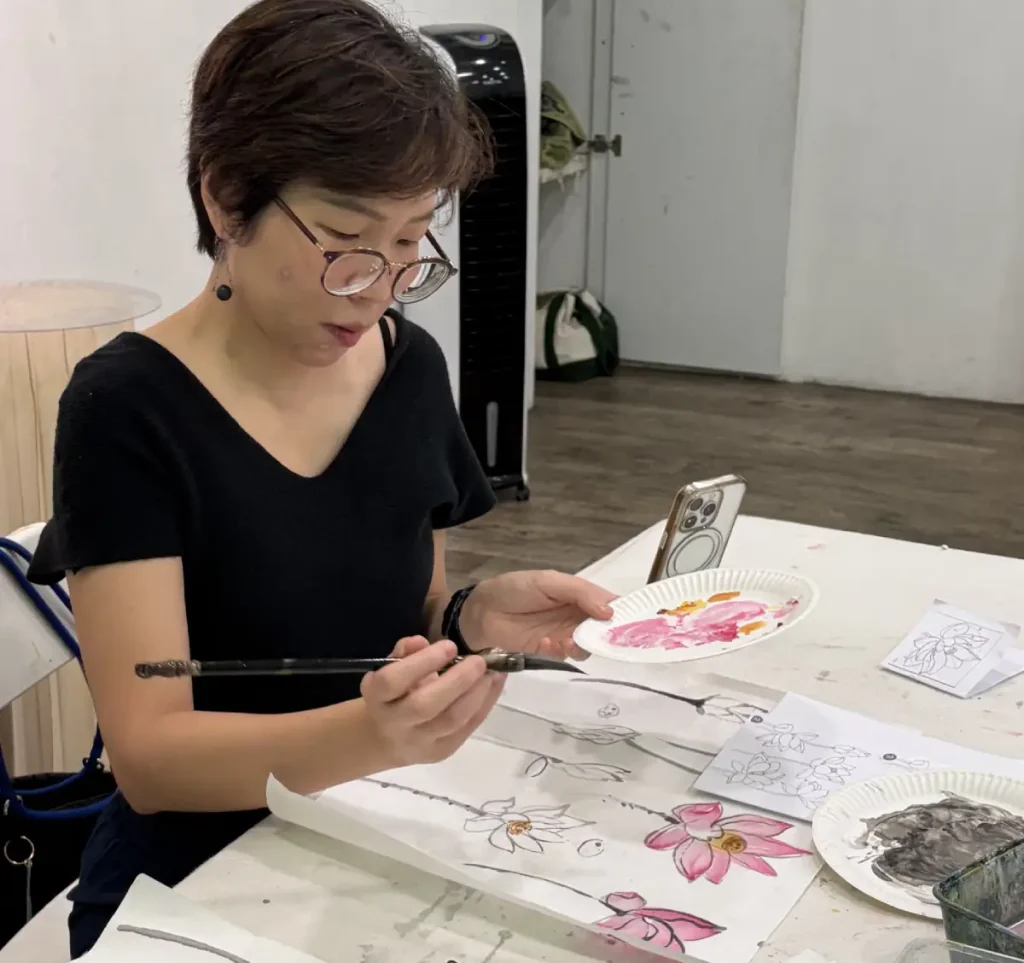 Students learning traditional Chinese ink painting techniques in Singapore