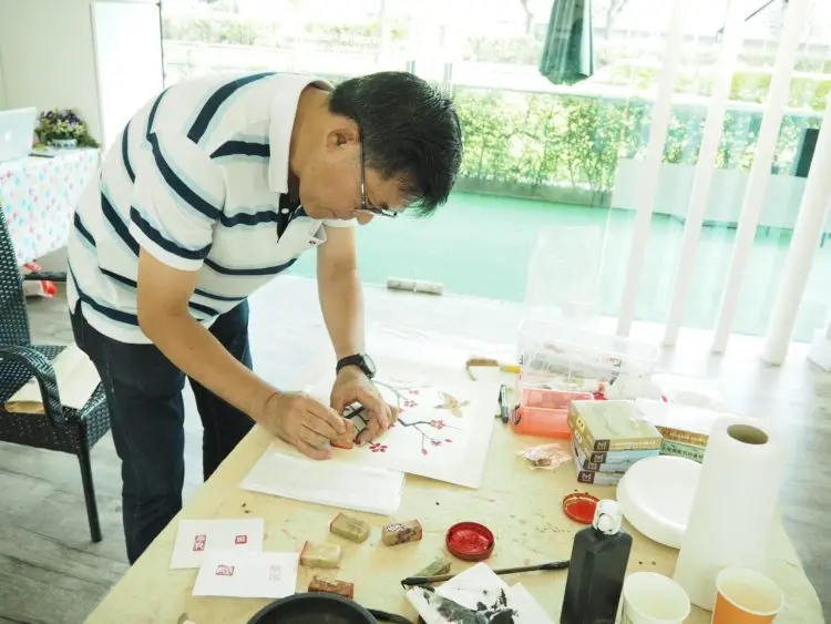 Demonstration of applying seals on Chinese ink painting for composition and styling of work
