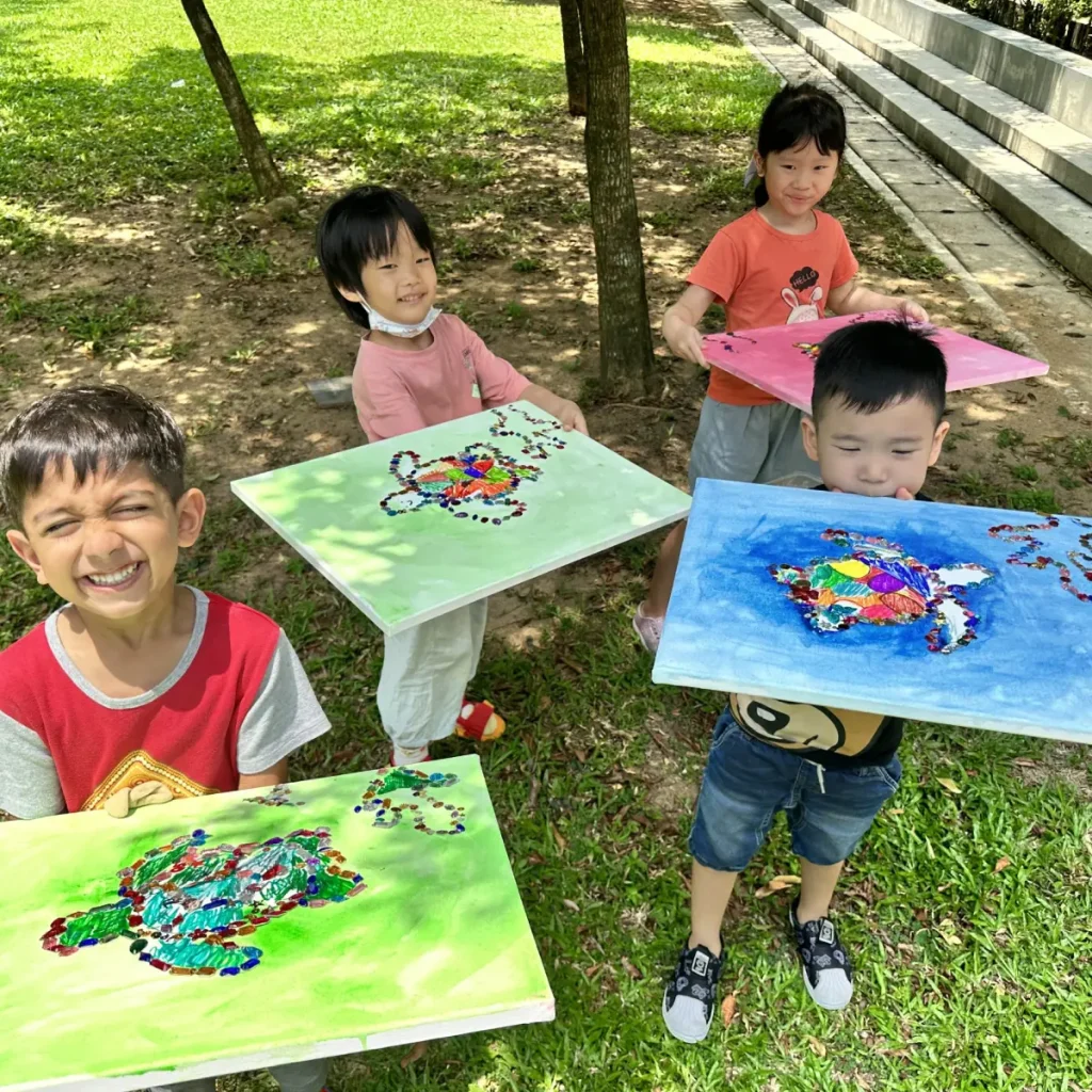 Children engaged in various art activities during the Kids Art Immersion Course
