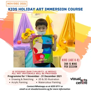An excited child painting with watercolors in Holiday Art Immersion Programme session