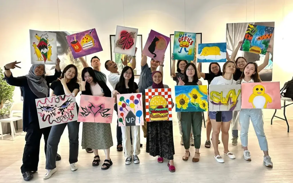 Participants are trying fun graffiti spray Graffiti Spray Painting on mural team bonding art jamming Visual Arts Centre Singapore