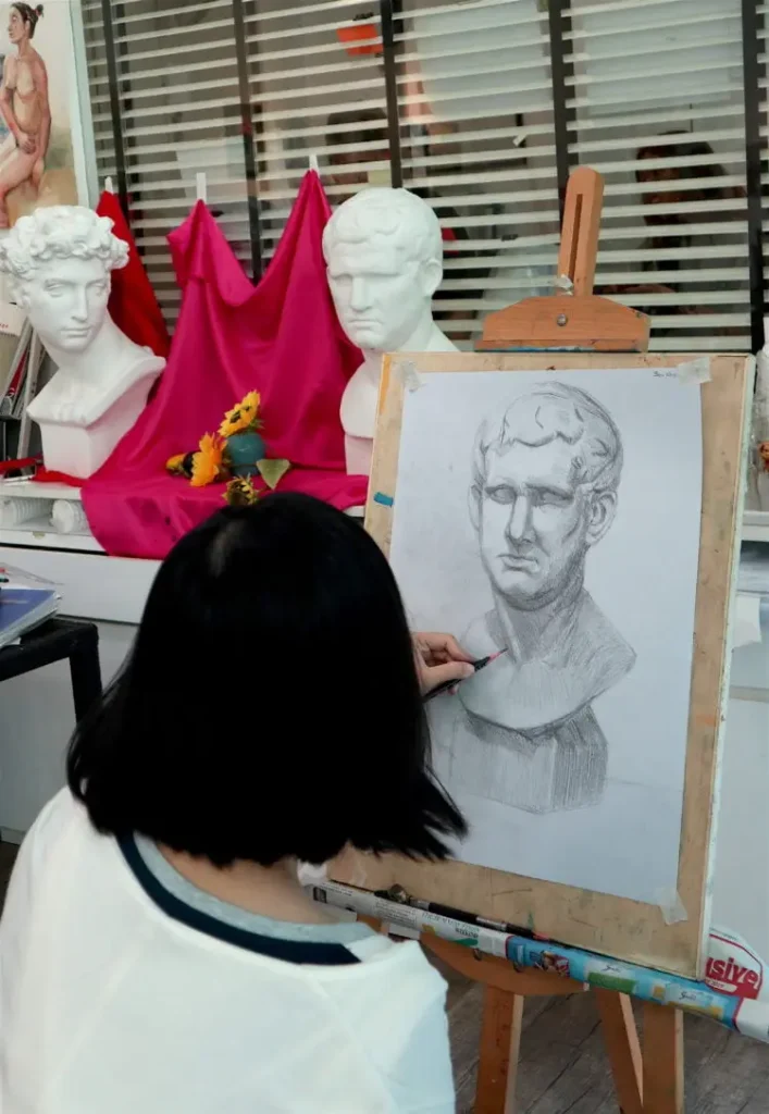 Student doing sketch of an intermediate level plaster cast