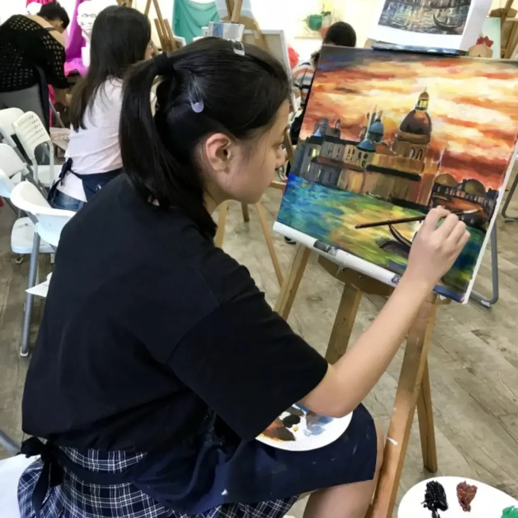 Students sketching and painting in a professional art immersion course during a studio session