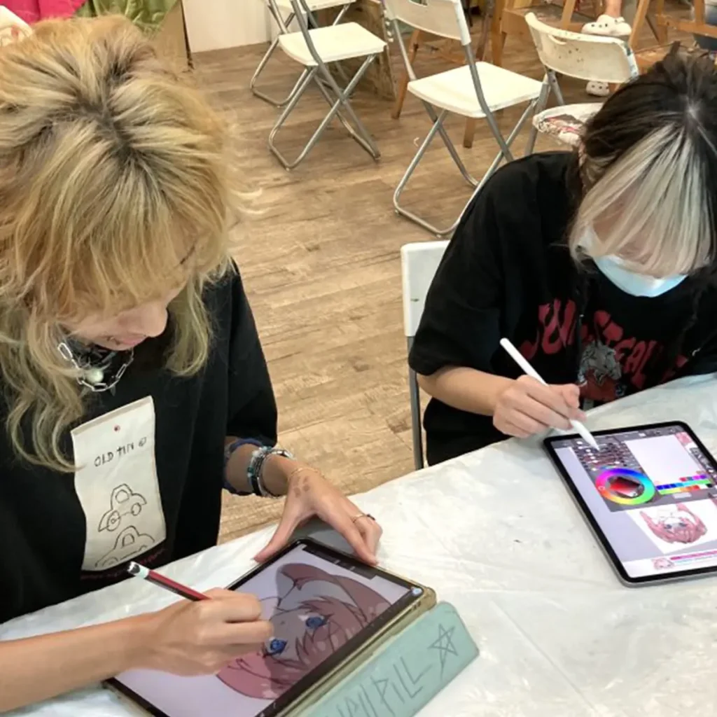 Artist creating manga character illustrations using digital painting tools