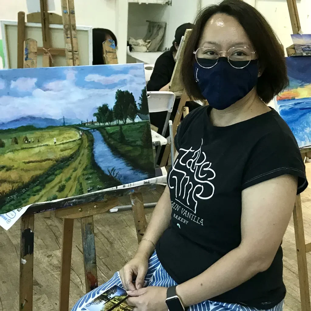 Student painting a scenic landscape during a Professional Acrylic Painting Ala Carte session at Visual Arts Centre Singapore