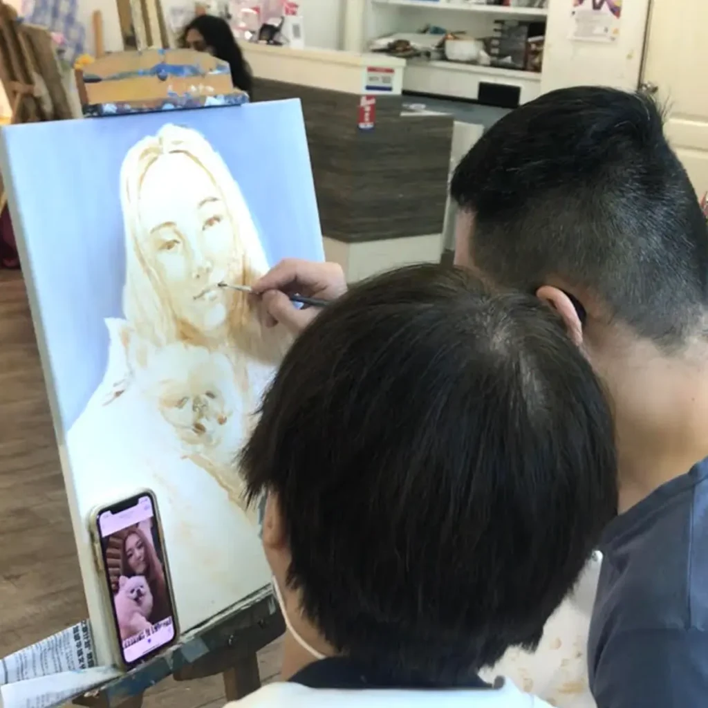 Artist painting a live portrait using the alla prima technique during a class at Visual Arts Centre Singapore