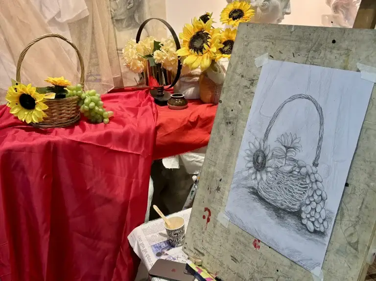 student preparing her diploma art portfolio by enhancing her still-life drawing and sketching skills