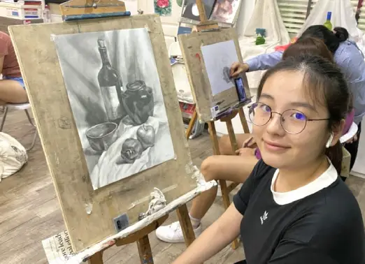 Student with her completed still life sketching 