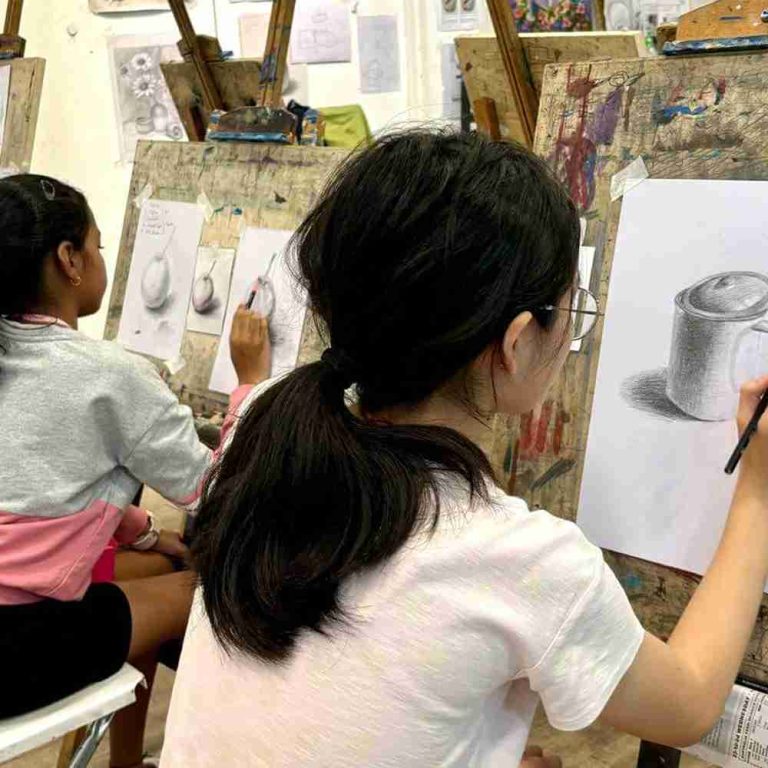 Student is focusing on her still-life sketching