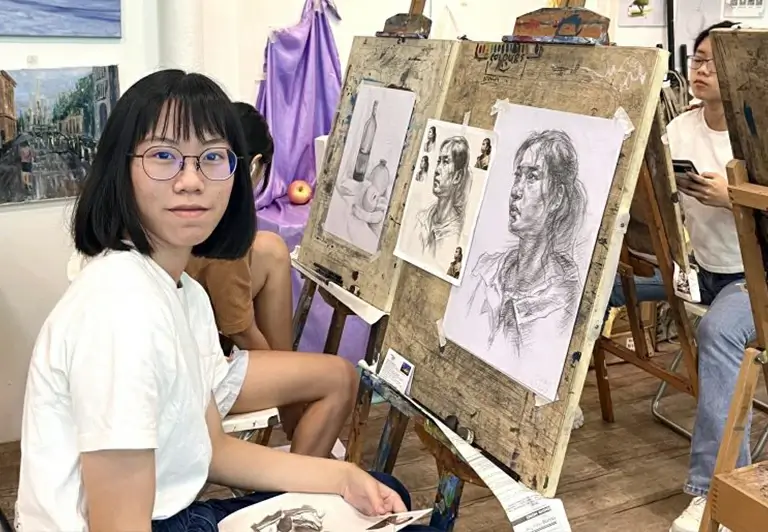Student with her completed Portrait Drawing and Sketching artwork Visual Arts Centre Singapore
