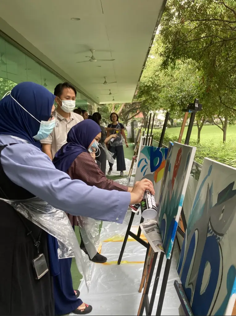 Graffiti spray painting on canvas team bonding team building art jamming Visual Arts Centre