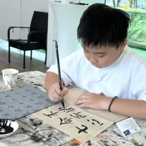Children practising traditional Chinese ink painting techniques