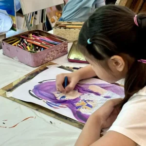 Children drawing manga and anime characters during an art class