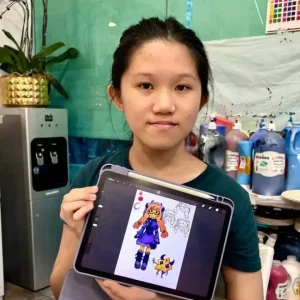 Student proudly holding up an iPad showing her digital drawing of an anime-style character, created during a digital art costume design class